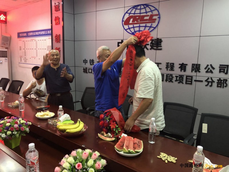 图4、五公司总经理助理、城开项目部经理申家喜为穆国彬同志戴上大红花（摄影：何娇龙）
