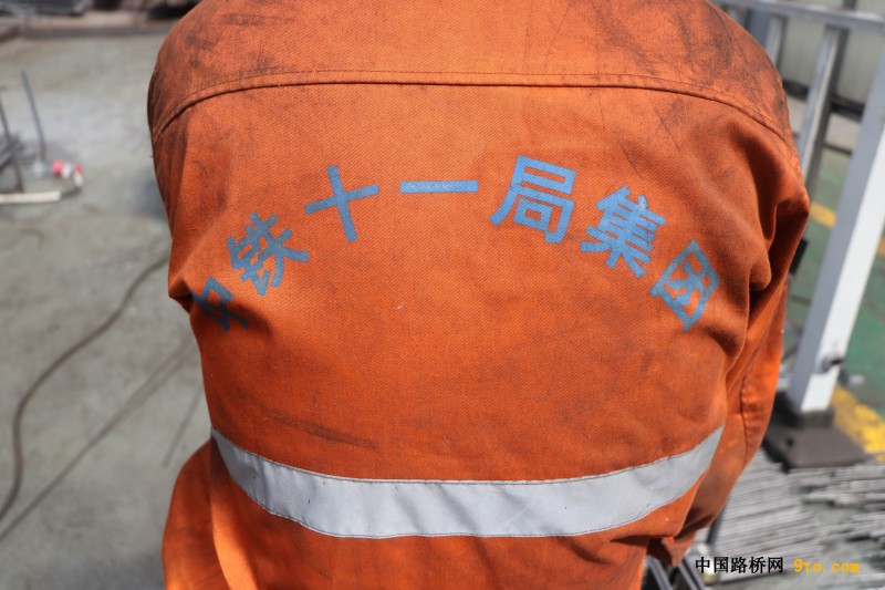 企业标志在汗水与污渍交汇的工作服上越发熠熠生辉
